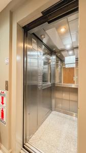 a walk in closet with a sliding glass door at Le Batiment Apartments in Buenos Aires