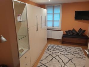 a large white cabinet in a living room with a window at Ferienwohnung Camino in Jockgrim