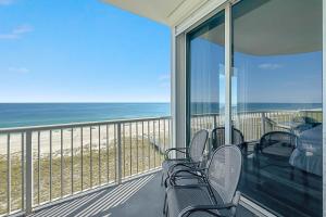a balcony with chairs and a view of the ocean at Spanish Key Unit 602 in Pensacola