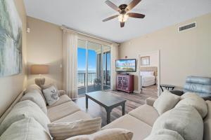 a living room with a couch and a tv at Spanish Key Unit 602 in Pensacola