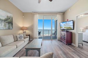 a living room with a couch and a tv at Spanish Key Unit 602 in Pensacola +64 photos