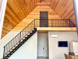 a staircase in a house with a wooden ceiling at A Frame Villa Gabala in Gabala