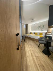 a hotel room with a bed and a table and chairs at Nebula Apartments in Tirana