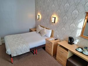 Postel nebo postele na pokoji v ubytování Prince Of Wales Hotel