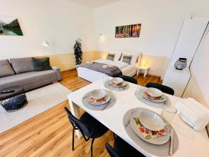 a living room with a white table and chairs at Apartment Miramare in Neunkirchen