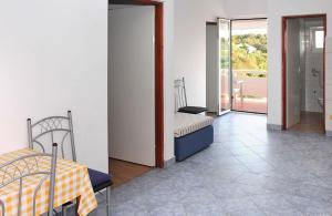 a bedroom with two beds and a balcony at Apartments Vink in Vir