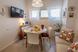 a small dining room with a table and a couch at Apartment Ljubav in Makarska