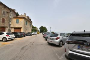 a row of cars parked on the side of a street at Apartment Leprin in Labin