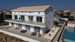 an aerial view of a house with a swimming pool at Astro apartments with direct access on the sea of Noto heritage of Unesco in Noto