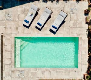 an overhead view of a swimming pool with two lounge chairs at Casa Guarda Island Lošinj in Veli Lošinj