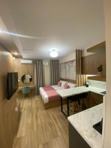 a hotel room with a bed and a desk at Nebula Apartments in Tirana