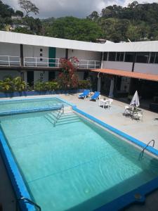 a large swimming pool in front of a building at Pacific Coast Hotel in Playa Bonita Village