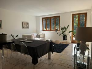 a living room with a table and a couch at Ferme de Grandchamp in Boudry