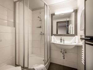 a bathroom with a shower and a sink at The Black by Regina in Sölden