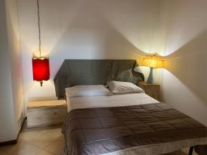 a bedroom with a bed with a red lamp at Mood-Rezia 14 in Pavia