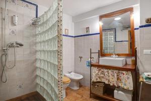 a bathroom with a shower and a toilet and a sink at Casa calle del Carmen in Grazalema +16 photos