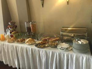 a table with plates of food on top of it at Hotel Pejton in Prishtinë +39 photos