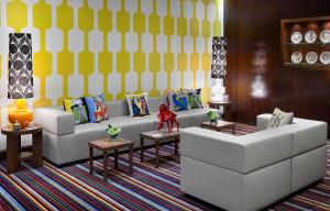a living room with a white couch and tables at Hôtel Juana in Juan-les-Pins