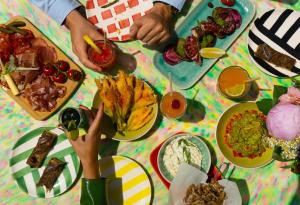 a table with plates of food on it at Hôtel Juana in Juan-les-Pins