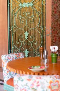 a wooden table and chairs with a table and a table at Hôtel Juana in Juan-les-Pins