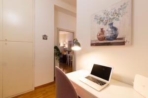 a laptop computer sitting on a desk in a room at Linate Retreat - Forlanini M4 in Milan