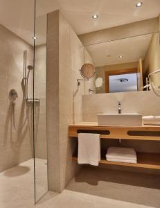 a bathroom with a sink and a shower at Noldis Apart in Serfaus