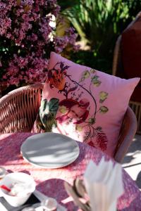 a table with a pillow and a plate on a table at Hôtel Juana in Juan-les-Pins
