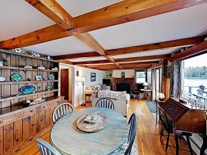 a living room with a table and chairs at Noonie's Nest Waterfront Cottage on Mount Desert Isle in Pretty Marsh +22 photos