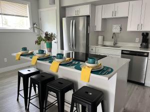 La cuisine est équipée d'un comptoir avec tabourets et d'un réfrigérateur. dans l'établissement Sun Deck 201, à Old Orchard Beach
