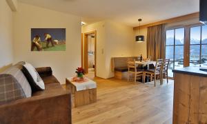 a living room and kitchen with a couch and a table at Noldis Apart in Serfaus