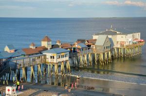 a group of buildings on the beach next to the ocean at Lido Deck 101 in Old Orchard Beach