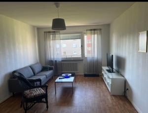 a living room with a couch and a tv at Lägenhet 2 rum & kök i töreboda in Töreboda