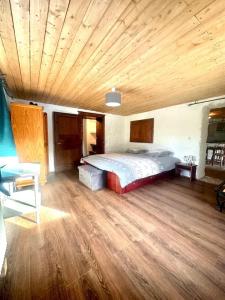 a bedroom with a bed and a wooden ceiling at Appartement confortable à Gerbépal 55 m² avec sauna in Gerbépal