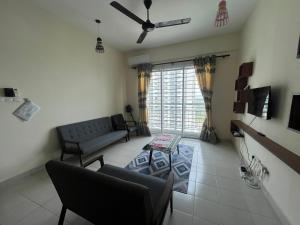 a living room with a couch and a table at Sandakan Homestay & Backpackers in Sandakan