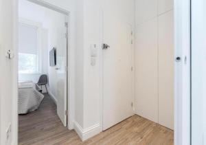 a white room with white cabinets and a bedroom at Babylon Piccadilly in London