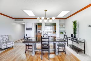 a dining room and living room with a table and chairs at Walk to Paradise Hills Golf Course Condo with Patio in Albuquerque