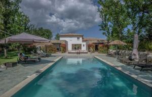a large swimming pool in front of a house at Belvillas in Montauroux