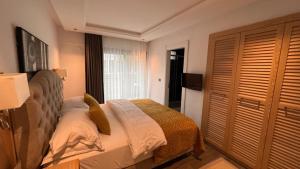 a bedroom with a bed and a television in it at Casa Mimosa Hotel in Karaburun