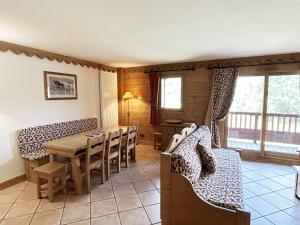 a dining room with a wooden table and chairs at Appartement de standing 8 pers avec piscine, spa, parking inclus - FR-1-461-1 in Saint-Martin-de-Belleville