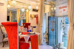 Un comedor con una mesa y sillas rojas. en Venice Luxury Watersdoor, en Venecia
