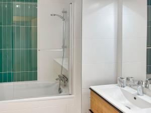 a bathroom with a tub and a sink and a shower at Le Repos Chartrain in Chartres +29 photos