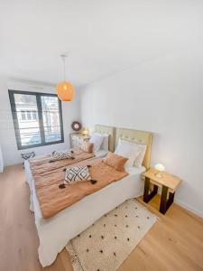 a bedroom with a large bed and a table at Le Repos Chartrain in Chartres