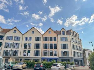 a large building with cars parked in a parking lot at Le Repos Chartrain in Chartres
