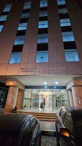 a person standing in front of a building at Lavish Private Rooms in Sharjah