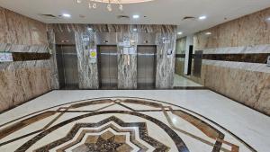 a bathroom with a mosaic tile floor in a building at Lavish Private Rooms in Sharjah