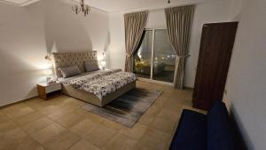 a bedroom with a bed and a large window at Lavish Private Rooms in Sharjah