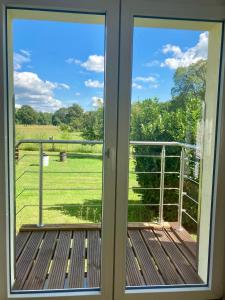 a window view of a field from a porch at Ferienwohnung Wiesenglück in Burg Kauper