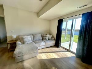 a living room with a couch and a large window at Papillion The White Pine Modern Spacious with Garage in Papillion