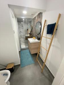 a bathroom with a shower and a sink and a mirror at Queluz Maison in Queluz