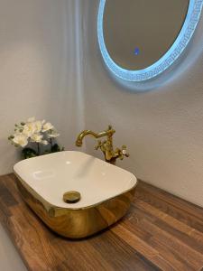 a bathroom with a wooden sink and a mirror at Milennium Apart Hotel in Bucharest +19 photos